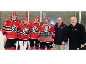 Sean Chisholm (left), Tyler Parr, Evan Dowd and Malcolm McLeod of the Mitchell Hawks accept the trophy for winning the 2021-22 PJHL Pollock Division championship from PJHL Commissioner Terry Whiteside and North Conference Commissioner Doug Kennedy in Hanover April 16. The Hawks won Game 7 8-0 to take the series, 4-3. They will host Stayner in Game 1 of their PJHL North Conference final this Friday, April 22 at 7:30 p.m.  (ANDY BADER/Postmedia Network)