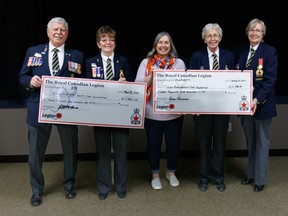 (From left to right) Bob Mcleod and Nancy Tonn of the Okotoks Royal Canadian Legion, Executive Director of the High River District Healthcare Foundation Wendy Kennelly, Rosalyn Richardson and Linda Reed of the High River Royal Canadian Legion pose with cheques donated to the High River District Healthcare Foundation in High River on Thursday, Mar. 31. The cheques are being used to purchase new equipment for the hospital in High River.