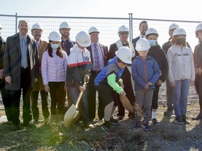 Six students from Mother Teresa Catholic School, front, from left, Lilian Misner, Ana-Sofia Escobedo, Thomas Korzeniowski, Joseph Misner, Nicholas Korzeniowski and Andrea Escobedo, joined dignitaries and guests for the groundbreaking ceremony for the new Algonquin and Lakeshore Catholic District School Board Kingston west elementary school on Holden Street.
