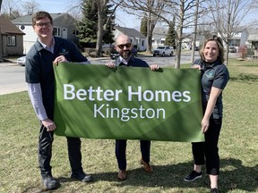 Peter Huigenbos, commissioner of business, environment and projects, from left, Chris Boivin, managing director of the Federation of Canadian Municipalities, and Kingscourt-Rideau District Coun. Mary Rita Holland hold a sign marking the launch of the Better Homes Kingston retrofit program on Monday.
