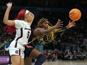 UConn Huskies forward Aaliyah Edwards (3) moves the ball up the court against South Carolina Gamecocks forward Victaria Saxton (5) during the second half in the Final Four championship game of the women's college basketball NCAA Tournament in Minneapolis, Minn., on Sunday.