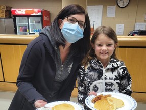 Shannon Gagne and her daughter Sophie enjoyed the pancake breakfast as they cheered on the Espanola Eagles U9 team.