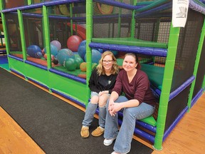 Photo by Jacqueline RivetOwner Ashley Moga (left) and employee Serena Golden sit inside a cubby hole beside the bouncy ball pit. Some of the activities at Moga Mania include slides, climbing and bouncing features. All are designed to encourage children to have fun while becoming physically active.