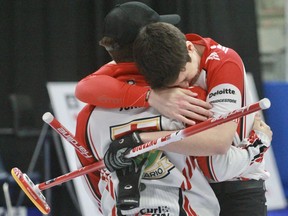 Team Ontario 1 teammates Austin Snyder and Jacob Jones, both from Brantford, embrace after winning the U21 national curling championship Friday afternoon in Stratford.