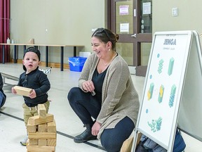 EDUCATIONAL Talon Neveau and his mother Reanne Zack check out the Jenga workstation at the Garden River First Nation Recreation Centre in April, when parts of the show were presented. BOB DAVIES