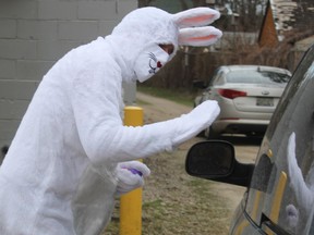 Jeff Classen, as the Easter Bunny, waves to a fan during a drive-thru Easter family event the Petrolia Lions Club hosted Friday at Greenwood Park in Petrolia.