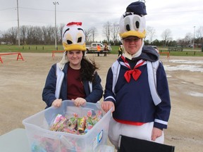 Natalee Bourn, left, and Austin Welch help man a drive-thru Easter family event the Petrolia Lions Club hosted Friday at Greenwood Park in Petrolia.