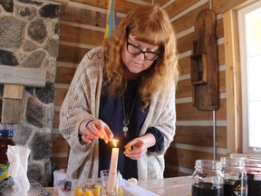Cat Cabajar demonstrates Ukrainian Easter egg decorating in the log cabin at Canatara Park on Saturday during Easter in the Park.