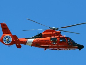 A Canadian Coast Guard helicopter circles above during a rescue of two men whose canoe capsized on Wednesday, April 20, 2022 in Ipperwash Beach, Ont.  Terry Bridge/Sarnia Observer/Postmedia Network