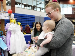 Katie Wright and her five-month-old baby, Piper, check out what's for sale during the Big Brothers Big Sisters of Sarnia-Lambton's Spring Show and Sale inside Lambton College's gym on Saturday, April 30, 2022, in Sarnia, Ont. Terry Bridge/Sarnia Observer/Postmedia Network