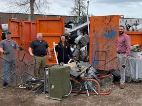 From left, Mike Ion, Simcoe Firefighters Association vice president; Reg Ellie, president;  Mike Lefler, treasurer; and Marcia VanHaverbeke, clean up the mess left by thieves rummaging through the scrap metal at the associaton's scrap metal donation bin. Theft is an ongoing problem at the site. ALEX HUNT