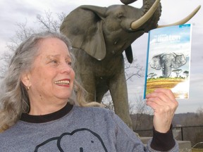 St. Thomas button collector Joanne Irons visits the Jumbo monument to show the latest number of The National Button Bulletin, which features Jumbo and elephant buttons. She penned the articles. Eric Bunnell