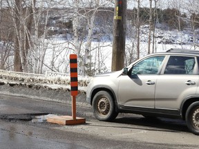 A hazard sign located on Bellevue Avenue in Sudbury, Ont., warns motorists of a large pothole on Friday March 11, 2022. John Lappa/Sudbury Star/Postmedia Network