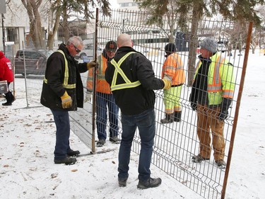 Workers erect fencing at Memorial Park in Sudbury, Ont. on Friday April 1, 2022. The City of Greater Sudbury set a deadline of April 1, 2022 for occupants of an encampment to leave the park. The City said in a short email that fencing was being erected "in the area of the encampment to allow for maintenance work and ground restoration to begin over the coming weeks/months." John Lappa/Sudbury Star/Postmedia Network