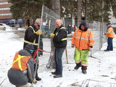 Workers erect fencing at Memorial Park in Sudbury, Ont. on Friday April 1, 2022. The City of Greater Sudbury set a deadline of April 1, 2022 for occupants of an encampment to leave the park. The City said in a short email that fencing was being erected "in the area of the encampment to allow for maintenance work and ground restoration to begin over the coming weeks/months." John Lappa/Sudbury Star/Postmedia Network