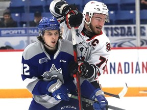 Ryan Smith, left, of the Sudbury Wolves, and Dakota Betts, of the Niagara IceDogs, battle for position during OHL action at the Sudbury Community Arena in Sudbury, Ont. on Friday April 1, 2022. John Lappa/Sudbury Star/Postmedia Network