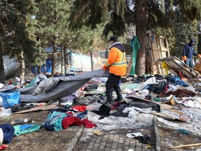 A crew from Reliable Cleaning Services remove debris from an encampment at Memorial Park on April 4. The City of Greater Sudbury set a deadline of April 1 for occupants of the encampment to leave the park.