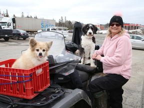 Fifteen-year-old Diogee, left, and Louie wait patiently on an ATV while Laura-Lea Barbeau has her lunch in Lively, Ont. on Tuesday April 5, 2022. John Lappa/Sudbury Star/Postmedia Network