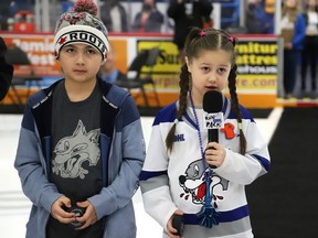 Riley Agowissa, 6, right, performs a song as Jace Gonawabi, 9, looks on at a pregame ceremony at the Sudbury Wolves game against the Niagara IceDogs at the Sudbury Community Arena in Sudbury, Ont. on Tuesday April 5, 2022. The ceremony was held to celebrate Indigenous culture. The Wolves partnered with Kina Gbezhgomi Child and Family Services to host the game. Five dollars from every ticket sold will go towards KGCFS to support its programs and events for foster children. John Lappa/Sudbury Star/Postmedia Network