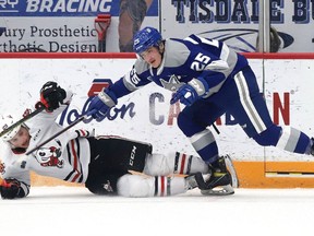 Dominik Jendek, right, of the Sudbury Wolves, and Alec Leonard, of the Niagara IceDogs, collide during OHL action at the Sudbury Community Arena in Sudbury, Ont. on Tuesday April 5, 2022. John Lappa/Sudbury Star/Postmedia Network