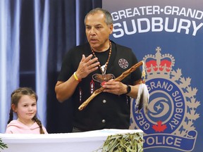 George Couchie (Shkaabewis), accompanied by his granddaughter, Faith, 7, addresses participants in an Indigenous welcoming ceremony for Couchie in Sudbury, Ont. on Thursday April 7, 2022. The special ceremony was held to welcome Couchie to the Greater Sudbury Police Spiritual Team. John Lappa/Sudbury Star/Postmedia Network