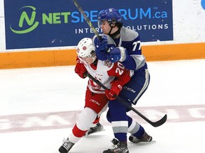 Nolan Collins, right, of the Sudbury Wolves, and Connor Toms, of the Soo Greyhounds, battle for the puck during OHL action at the Sudbury Community Arena in Sudbury, Ont. on Friday April 8, 2022. John Lappa/Sudbury Star/Postmedia Network