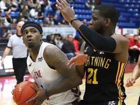 Jaylen Bland, left, of the Sudbury Five, attempts to shot over Abednego Lufile, of the London Lightning, during basketball action at the Sudbury Community Arena in Sudbury, Ont. on Thursday April 14, 2022. John Lappa/Sudbury Star/Postmedia Network