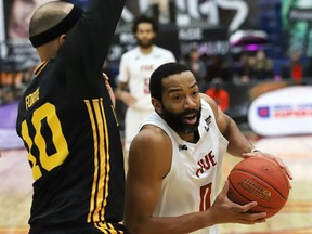 Evan Harris, right, of the Sudbury Five, drives to the basket against Cameron Forte, of the London Lightning, during basketball action at the Sudbury Community Arena in Sudbury, Ont. on Thursday April 14, 2022. John Lappa/Sudbury Star/Postmedia Network