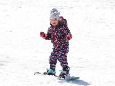 Three-year-old Lily Graveline found a patch of snow at Adanac Ski Hill to work on her snowboarding skills in Sudbury, Ont. on Thursday April 14, 2022. John Lappa/Sudbury Star/Postmedia Network