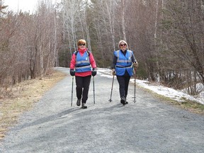 Muffie McIntosh, left, and Gisele Arlt go for an urban poling hike at one of the trails at Lake Laurentian Conservation Area in Sudbury, Ont. on Monday April 18, 2022. John Lappa/Sudbury Star/Postmedia Network
