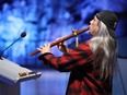 Sunny (David) Osawabine, of Debajehmujig Theatre Group, plays the flute at a funding announcement at Science North in Sudbury, Ont. on Friday April 22, 2022. John Lappa/Sudbury Star/Postmedia Network