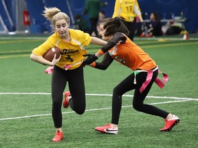 Kynlee Cresswell, left, of Bishop Alexander Carter, attempts to evade Julia Anderson, of the Lasalle Lancers, during flag football action at the Lancer Flag Football Senior Tournament at the Lancer Dome in Sudbury, Ont. on Thursday April 28, 2022. John Lappa/Sudbury Star/Postmedia Network