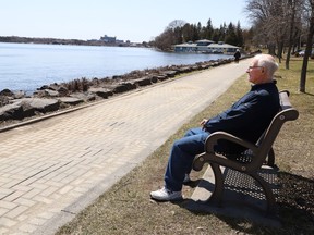 Barry Johnson takes a breather while enjoying the view near Bell Park at Ramsey Lake in Sudbury, Ont. on Thursday April 28, 2022. John Lappa/Sudbury Star/Postmedia Network