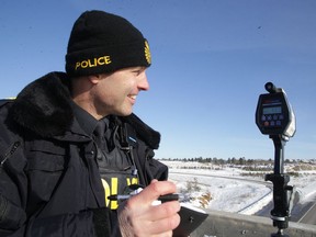 Sgt. Straun Frederiksen works the Lidar on a Highway 69 overpass in Sudbury, Ont. on Wednesday January 24, 2018. He has been charge in connection with property taken from a detachment evidence vault. Gino Donato