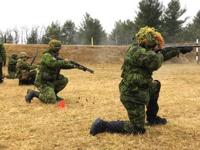 Canadian Rangers, engaged in training, fire shotguns at targets on a shooting range.

Sgt. Peter Moon/Canadian Rangers