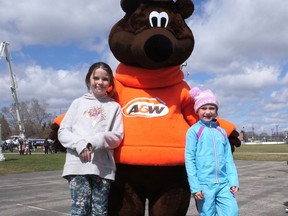 Isabella Martin and Leila Jackson met the A&W Great Root Bear Saturday at the Tillsonburg Kinsmen Easter Egg Hunt. (Chris Abbott/Norfolk and Tillsonburg News)