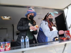 Jaslyn Chevers and Isabella Edwards volunteered at the Tillsonburg Kinette food truck during the Easter Egg Hunt Saturday. (Chris Abbott/Norfolk and Tillsonburg News)