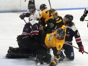 Tillsonburg Thunder’s Derek Slaght (8) and Scott Stafford (77) battle for the puck in front of Elora Rocks’ net Saturday night during Game 6 of the WOSHL best-of-seven finals. CHRIS ABBOTT