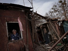 Lidiya Mezhiritska stands inside her damaged house after a rocket exploded outside, in a residential area in Kharkiv, as Russia's attack on Ukraine continues, Ukraine, April 8, 2022.  REUTERS/Thomas Peter