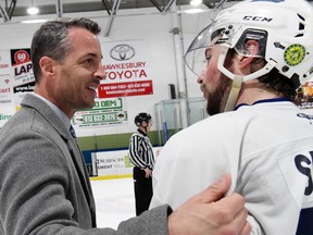 Brockville head coach Randy Jones congratulates Hawks centre and former Brave Josh Spratt at the end of the semi-final series in Hawkesbury on Saturday night. Doug Petepiece photo