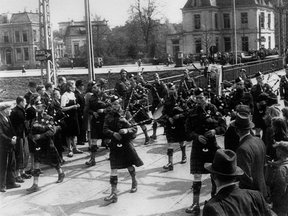 Members of the Essex and Kent Scottish Regiment Pipe and Drums are seen here marching over a bridge during the liberation of Groningen, Netherlands in April 1945. (Handout)