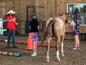 Acceptional Riders facilitator Cynthia Cote guides participants through a new equine-assisted learning and life skills program at TJ Stables in Chatham, made possible through an Ontario Trillium Foundation grant. (Handout)