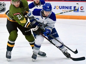 Brandon Coe of the North Bay Battalion battles Alex Assadourian of the Sudbury Wolves in action in November. Coe has been named Overage Player of the Year.
Sean Ryan Photo