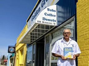 Don Neher, the owner of Melfort's Golden Grain Bakery, with a copy of Only in Saskatchewan. The book highlights recipes from across the province, and it's front cover is Golden Grain Bakery. Omar Sherif / The Journal