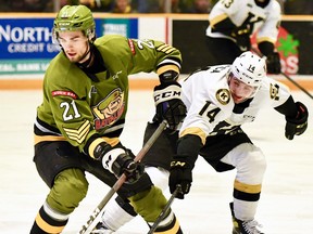 Brandon Coe of the North Bay Battalion shields the puck from Jordan Frasca of the visiting Kingston Frontenacs in their Ontario Hockey League second-round playoff opener Friday night. The teams face off again Sunday at Memorial Gardens.
Sean Ryan Photo