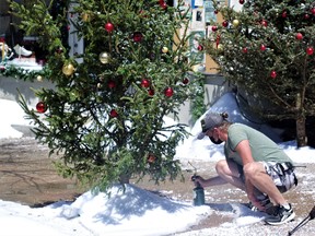 An employee on Main Street in Powassan creates fake snow for the next scene of the upcoming movie The Christmas Farm.
Rocco Frangione Photo