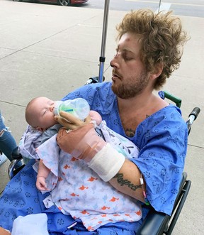 Clayton Ball holds his newborn son Briar a couple of days after the then-24-year-old Sarnia resident was injured in a hit-and-run crash on Aug.  21, 2020. (GoFundMe)