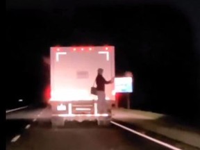 Ontario Provincial Police are investigating after a video was posted to social media showing a person hitching a ride on the back of a truck on Highway 24. TWITTER