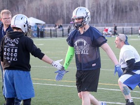 Sudbury Spartans Zach Pecman, centre, and Kyle Henri, right, warm up for practice at James Jerome Sports Complex in Sudbury, Ontario on Wednesday, May 4, 2022.