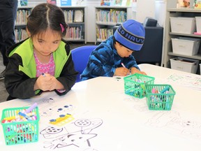 Siblings Pia (left), and Jan (right), six and four years-old respectively, colour pictures in Forest Library’s newly-renovated children’s section during the library’s re-opening on May 3.
Carl Hnatyshyn/Sarnia This Week